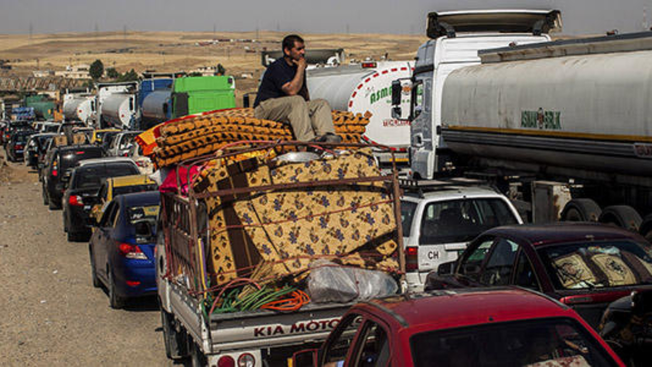 People leaving areas controlled by the Islamic State in Iraq and Syria wait to clear the Khazer checkpoint between Mosul and Erbil in Iraq, June 14, 2014. A rebel juggernaut that captured Iraq's second-largest city and raced south in three days, raising fears of the imminent fall of Baghdad, stalled for a second day on Saturday about 60 miles north of the capital, leaving residents bracing for a siege that so far has not happened. (Bryan Denton/The New York Times)