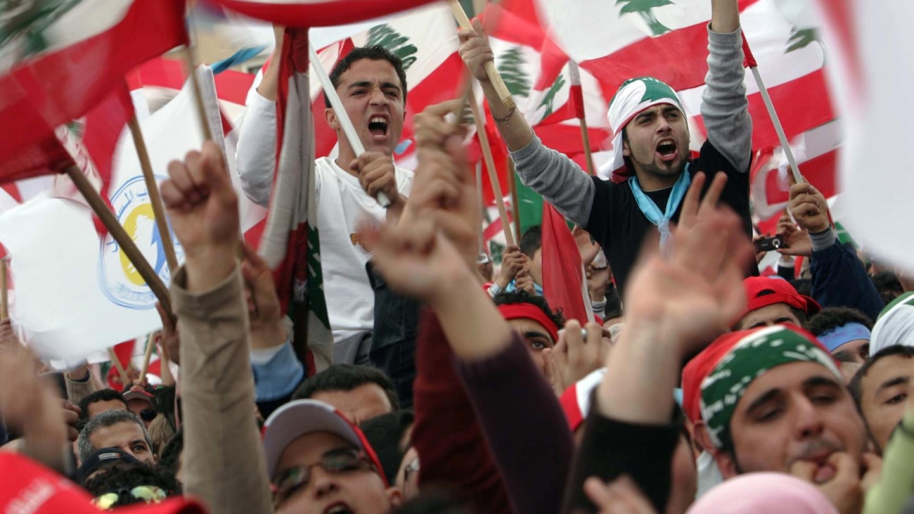 (NYT12) BEIRUT, Lebanon -- Feb. 14, 2007 -- LEBANON-3 -- Pro-government demonstrators wave the flag of Lebanon during a rally in Beirut on Wednesday, Feb. 14, 2007, the second anniversary of his assassination. The Lebanese military rolled out acres of razor wire and fashioned a no-manÕs land to separate the hundreds of thousands of pro-government supporters who poured into the center of Beirut from the hundreds of opposition supporters who have camped in the downtown since December. (Shawn Baldwin/The New York Times)