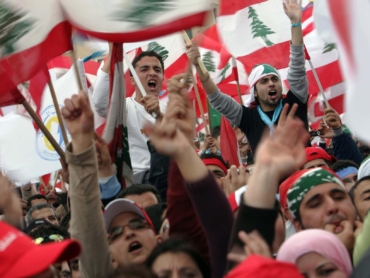 (NYT12) BEIRUT, Lebanon -- Feb. 14, 2007 -- LEBANON-3 -- Pro-government demonstrators wave the flag of Lebanon during a rally in Beirut on Wednesday, Feb. 14, 2007, the second anniversary of his assassination. The Lebanese military rolled out acres of razor wire and fashioned a no-manÕs land to separate the hundreds of thousands of pro-government supporters who poured into the center of Beirut from the hundreds of opposition supporters who have camped in the downtown since December. (Shawn Baldwin/The New York Times)