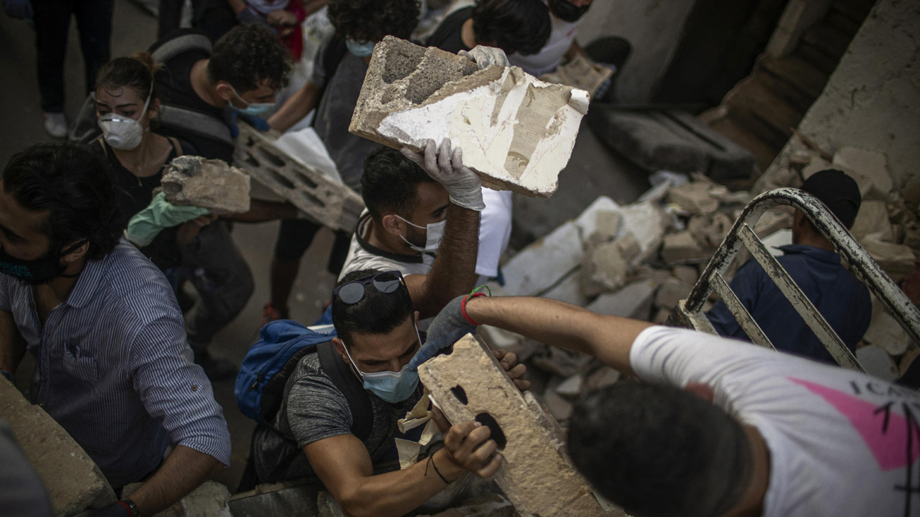 People search through rubble on Thursday, Aug. 6, 2020, in Beirut, resulting from an explosion two days earlier. Lebanon began an official period of national mourning on Thursday, two days after a powerful explosion in Beirut flattened whole neighborhoods in the bustling metropolis. (Diego Ibarra Sanchez/The New York Times)