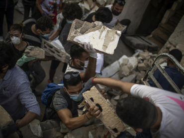 People search through rubble on Thursday, Aug. 6, 2020, in Beirut, resulting from an explosion two days earlier. Lebanon began an official period of national mourning on Thursday, two days after a powerful explosion in Beirut flattened whole neighborhoods in the bustling metropolis. (Diego Ibarra Sanchez/The New York Times)