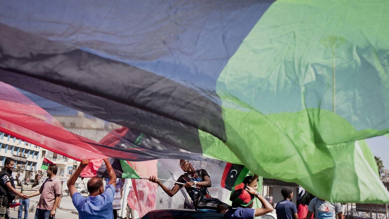 Libyans celebrate in the afternoon during elections in Benghazi, Libya, July 7, 2012. Determined to conceive a new nation after the overthrow of Moammar Gadhafi, Libya braved sporadic gunfire and threats of violence to cast ballots Saturday. (Tomas Munita/The New York Times)