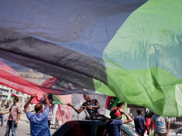 Libyans celebrate in the afternoon during elections in Benghazi, Libya, July 7, 2012. Determined to conceive a new nation after the overthrow of Moammar Gadhafi, Libya braved sporadic gunfire and threats of violence to cast ballots Saturday. (Tomas Munita/The New York Times)