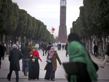 People walk along Avenue Habib Bourguiba in downtown Tunis, Tunisia, Feb. 11, 2013. The avenue, named for Tunisia's first post-independence leader, has absorbed more than a century of Tunisia's struggles; and in its best moments, the avenue forges a community even when the country seems at odds. (Tara Todras-Whitehill/The New York Times)