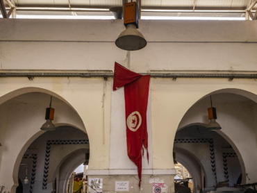 A tattered Tunisian flag at the Marche Central, a market in downtown Tunis, Tunisia, Sept. 28, 2021. Tunisia, birthplace of the pro-democracy uprisings that swept the Arab world, now looks to many like a final confirmation of failed promise. (Ivor Prickett/The New York Times)