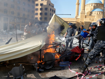 Lebanese police put out a fire set by men who attacked anti-government protesters' tents, during ongoing anti-government protest, Lebanon October 29, 2019. REUTERS/Mohamed Azakir