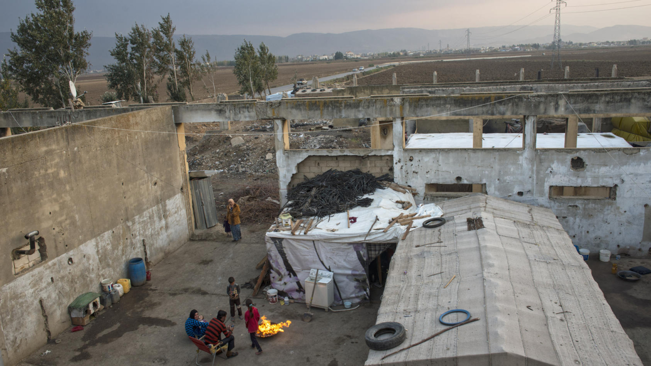 Syrian refugees live in a factory bombed by the Israeli military in 1982 near Faida, Lebanon, Nov. 14, 2013. Citing the country's tortured history with Palestinian refugees, Lebanon has not established camps for Syrians, leaving many in ad-hoc "urban refugee" situations where they have proven particularly difficult to reach with aid.(Lynsey Addario/The New York Times) -- NO SALES.